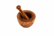 Natural olive wood pestle grinding herbs
